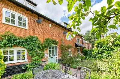 a brick house with a table and chairs in the yard at 4 Bed in Halesworth oc-5river in Halesworth
