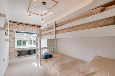 a bedroom with a bunk bed and a window at 4 Bed in Halesworth oc-5river in Halesworth