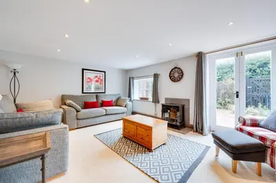 a living room with a couch and a fireplace at 4 Bed in Halesworth oc-5river in Halesworth