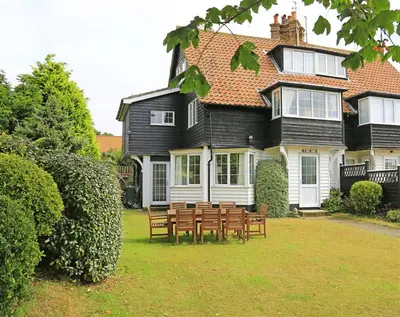 a group of chairs in front of a house at 4 Bed in Thorpeness oc-bays in Thorpeness