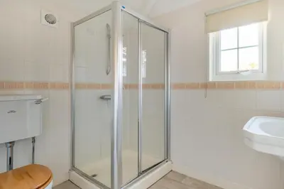 a glass shower in a bathroom with a sink at 4 Bed in Thorpeness oc-bays in Thorpeness
