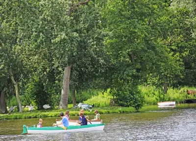 a group of people in a boat on the water at 4 Bed in Thorpeness oc-bays in Thorpeness