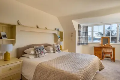 a bedroom with a bed and a desk and a chair at 4 Bed in Thorpeness oc-bays in Thorpeness