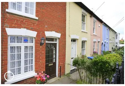 a red brick house with a black door at 2 Bed in Aldeburgh oc-prd in Aldeburgh