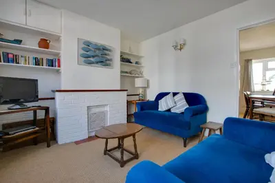 a living room with a blue couch and a fireplace at 2 Bed in Aldeburgh oc-prd in Aldeburgh
