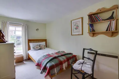 a bedroom with a bed and a chair in it at 2 Bed in Long Melford oc-9ws in Long Melford