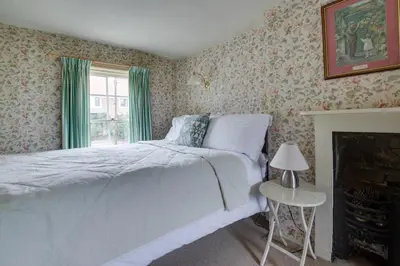 a bedroom with a white bed and a fireplace at 2 Bed in Long Melford oc-9ws in Long Melford