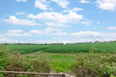 a field of green grass with a fence at 2 Bed in Long Melford oc-9ws in Long Melford