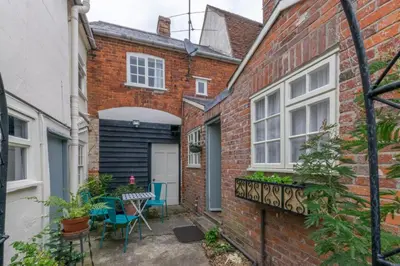 a courtyard in a brick house with a table and chairs at 2 Bed in Long Melford oc-9ws in Long Melford
