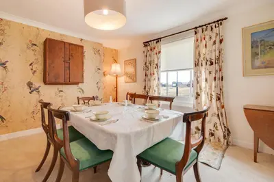 a dining room with a table and chairs and a window at 3 Bed in Aldeburgh oc-9king in Aldeburgh