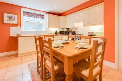 a kitchen with a wooden table and chairs at 3 Bed in Aldeburgh oc-9king in Aldeburgh