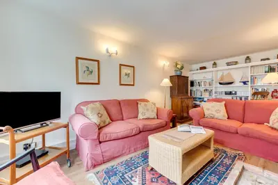 a living room with two pink couches and a flat screen tv at 3 Bed in Woodbridge oc-acot in Woodbridge