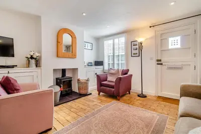 a living room with a couch and chairs and a fireplace at 2 Bed in Orford oc-sfcto in Orford