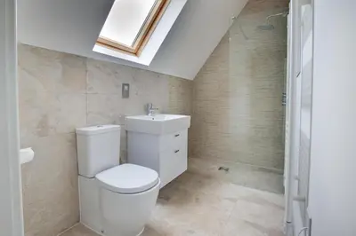 a bathroom with a toilet and a sink and a skylight at 4 Bed in Thorpeness oc-barrh in Thorpeness
