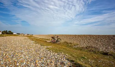 a bike parked on the side of a gravel road at 4 Bed in Thorpeness oc-barrh in Thorpeness