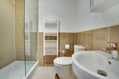 a bathroom with a toilet and a sink and a shower at 4 Bed in Thorpeness oc-barrh in Thorpeness