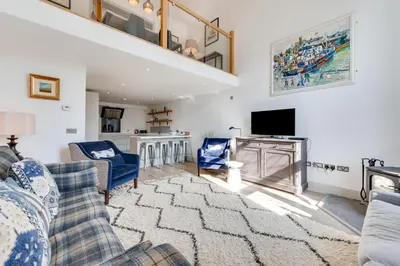 a living room with a couch and a tv at 4 Bed in Thorpeness oc-barrh in Thorpeness