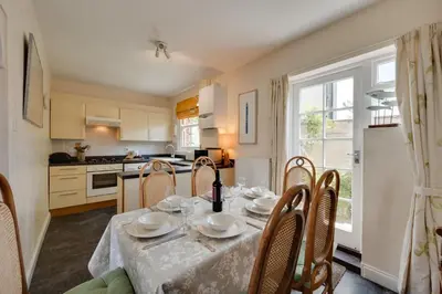 a dining room with a table and chairs and a kitchen at 3 Bed in Aldeburgh oc-ahs in Aldeburgh