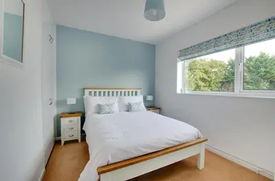 a white bedroom with a bed and a window at 3 Bed in Woodbridge oc-30mor in Woodbridge