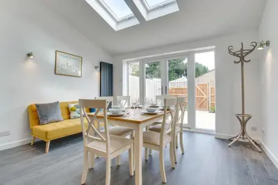 a dining room with a table and chairs and a couch at 3 Bed in Woodbridge oc-30mor in Woodbridge