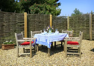 a table with four chairs and a blue and white table cloth at 6 Bed in Knodishall oc-bil in Aldringham