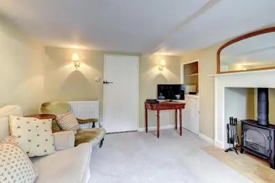 a living room with a couch and a table at 2 Bed in Iken oc-sfboo in Sudbourne