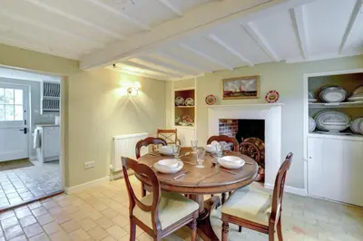 a dining room with a wooden table and chairs at 2 Bed in Iken oc-sfboo in Sudbourne