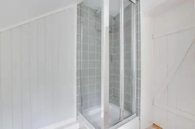 a glass walk in shower in a white room at 4 Bed in Eastbridge oc-bricot in Theberton