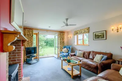 a living room with a couch and a tv at 4 Bed in Bramfield oc-sfbri in Bramfield
