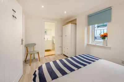 a bedroom with a bed and a window and a chair at 4 Bed in Friston oc-colu in Friston