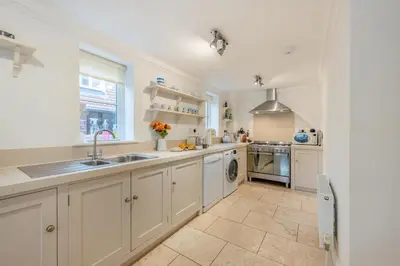 a large kitchen with white cabinets and a sink at 4 Bed in Friston oc-colu in Friston