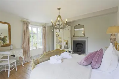 a bedroom with a white bed with towels on it at 5 Bed in Halesworth oc-cfl in Halesworth