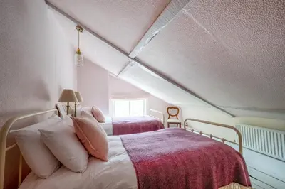 a bedroom with two beds in a attic at 5 Bed in Halesworth oc-cfl in Halesworth