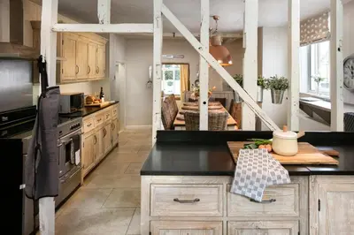 a kitchen with wooden cabinets and a black counter top at 5 Bed in Halesworth oc-cfl in Halesworth