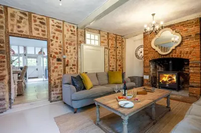 a living room with a couch and a fireplace at 5 Bed in Halesworth oc-cfl in Halesworth