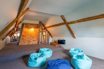 a living room with two blue chairs and a tv at 5 Bed in Halesworth oc-cfl in Halesworth