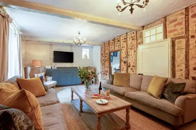 a living room with a couch and a table at 5 Bed in Halesworth oc-cfl in Halesworth