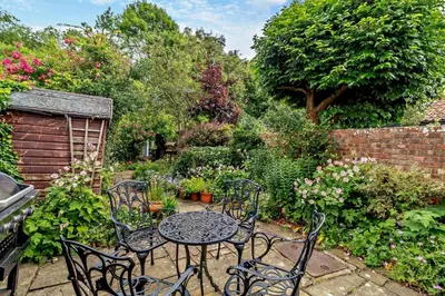 a patio with a table and chairs in a garden at 1 Bed in Yoxford oc-c27254 in Wickham Market