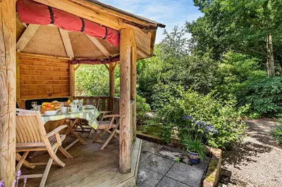 a wooden deck with a table and a gazebo at 1 Bed in Yoxford oc-c27254 in Wickham Market
