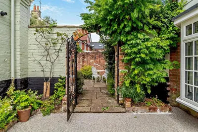 an entrance to a garden with an iron gate at 1 Bed in Yoxford oc-c27254 in Wickham Market