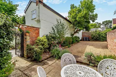 a garden with chairs and a gate in front of a house at 1 Bed in Yoxford oc-c27254 in Wickham Market