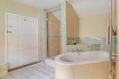 a large bathroom with a tub and a shower at 2 Bed in Yoxford oc-c27253 in Wickham Market