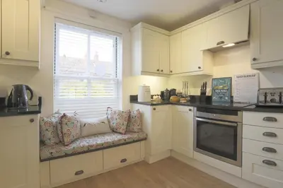 a kitchen with a bench with pillows and a window at 3 Bed in Eastbridge oc-cob in Theberton