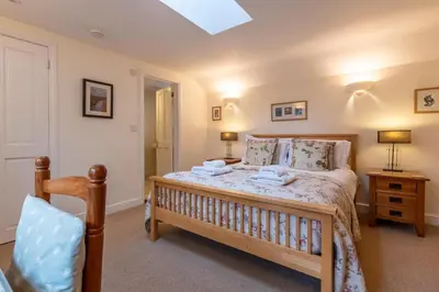 a bedroom with a bed with two towels on it at 3 Bed in Eastbridge oc-cob in Theberton