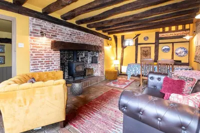 a living room with leather furniture and a fireplace at 2 Bed in Bramfield oc-cobb in Bramfield