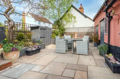 a patio with a table and chairs and a fence at 2 Bed in Bramfield oc-cobb in Bramfield