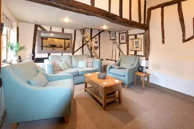 a living room with two blue chairs and a table at 2 Bed in Bramfield oc-cobb in Bramfield