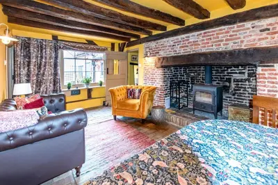 a bedroom with a brick wall and a fireplace at 2 Bed in Bramfield oc-cobb in Bramfield
