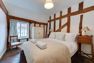 a bedroom with a large bed and a window at 2 Bed in Lavenham oc-24ss in Lavenham