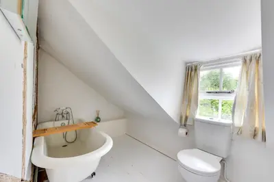 a white bathroom with a toilet and a sink at 2 Bed in Lavenham oc-24ss in Lavenham